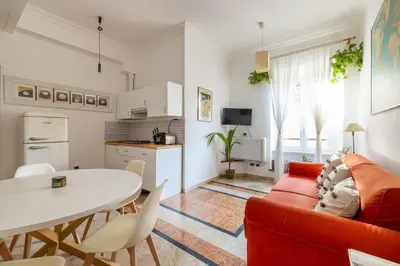 a living room with a red couch and a table at Maurice's Apt, hidden gem in Rome for food lovers in Rome