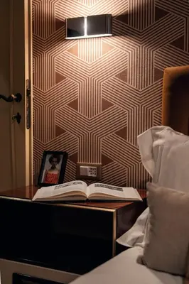a table with a clock and a book on it at Celeste Suite Reginella in Rome