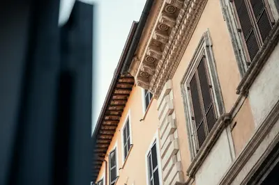 a building in a city with windows and a staircase at Celeste Suite Reginella in Rome