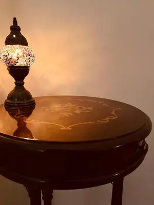 a table and a mirror on a wall next to a cabinet at La Casa di Monteverde in Rome