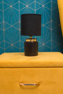 a lamp sitting on top of a dresser at Trastevere suites Luxury Garden Retreat in Rome