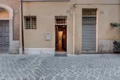 a building with two doors and a walkway at Suite Experience Spanish Steps Apartment in Rome