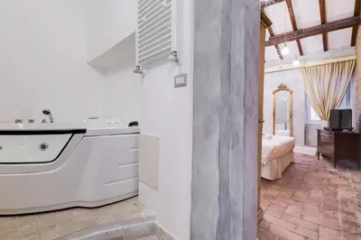 a bathroom with a tub and a sink in a room at Suite Experience Spanish Steps Apartment in Rome