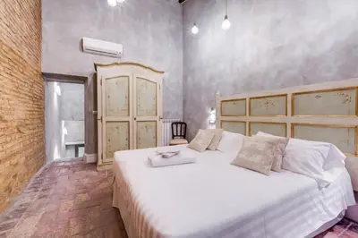 a bedroom with a large white bed in a room at Suite Experience Spanish Steps Apartment in Rome