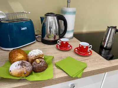 a cutting board with donuts and two cups of coffee at VMV Holiday houses in Rome