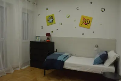 a bedroom with a bed and clocks on the wall at VMV Holiday houses in Rome