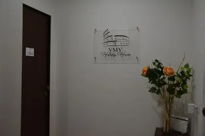 a vase of flowers and a picture on a wall at VMV Holiday houses in Rome