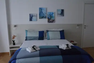 a bedroom with a bed with two towels on it at VMV Holiday houses in Rome