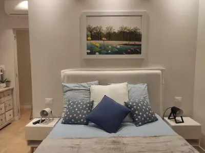 a bedroom with a bed with blue and white pillows at Anna Lucia's Flat vicino a Trastevere e al San Camillo in Rome