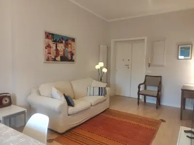 a living room with a white couch and a table at Anna Lucia's Flat vicino a Trastevere e al San Camillo in Rome