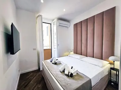 a bedroom with a large bed with two towels on it at Via Aubry 1- Vatican Museum in Rome