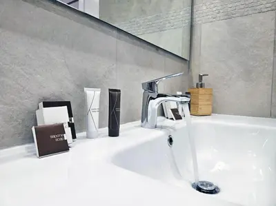 a bathroom sink with a faucet and other items on it at Via Aubry 1- Vatican Museum in Rome