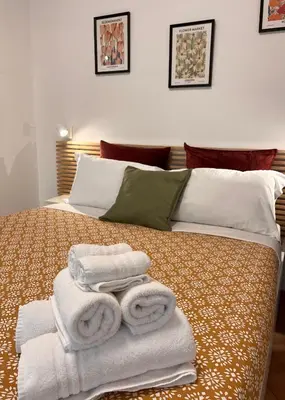 a room with a bed with towels on it at Sampietrino Vatican Apartment in Rome