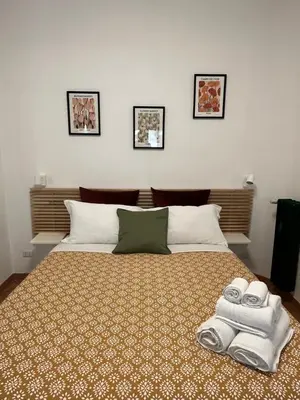 a bedroom with a bed with towels on it at Sampietrino Vatican Apartment in Rome