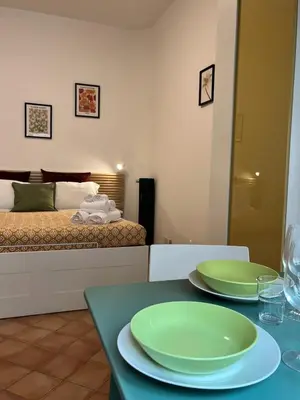 a bedroom with a bed and two green plates on a table at Sampietrino Vatican Apartment in Rome
