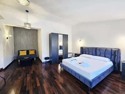 a bedroom with a large bed and a desk at Gabri 19 - Elegant Escape in Piazzale Flaminio in Rome