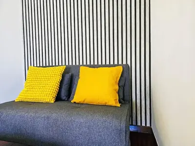 a bed with two yellow pillows on top of it at Gabri 19 - Elegant Escape in Piazzale Flaminio in Rome
