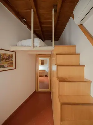 a room with a bunk bed and a staircase at Colosseum Apt in Rome