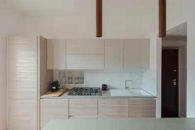 a kitchen with white cabinets and a stove top oven at Colosseum Apt in Rome