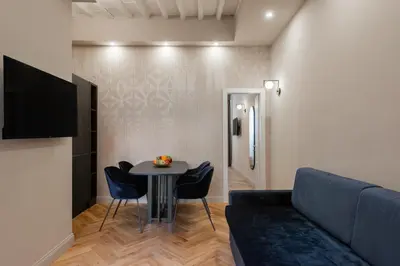 a living room with a couch and a table at H77 Apartments - Maison D'Art Collection in Rome
