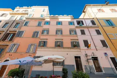 a building with an umbrella in front of it at H77 Apartments - Maison D'Art Collection in Rome