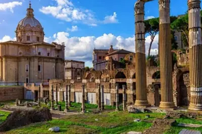 a view of the ruins of a building with columns at Central and Historic Rione near Colosseo in Rome