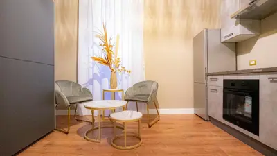 a kitchen with two chairs and a table and a window at Navona Comfort Rooms in Rome