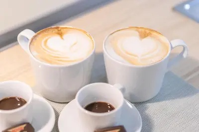 three cups of coffee sitting on a table at St Peter's Comfort Lodge in Rome