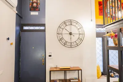 a clock on a wall next to a door at Design and Colorful Loft near Villa Pamphili in Rome