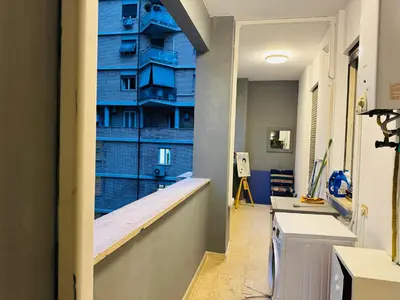 a hallway with a blue wall in a building at Trastevere Tales in Rome