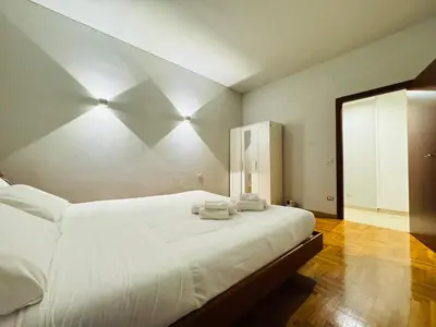 a bedroom with a white bed with towels on it at Trastevere Tales in Rome