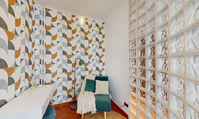 a room with a patterned wall with two chairs at Valery - Appartamento Glam vicino al Vaticano in Rome
