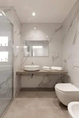 a bathroom with a sink and a toilet and a mirror at Koala House in Rome