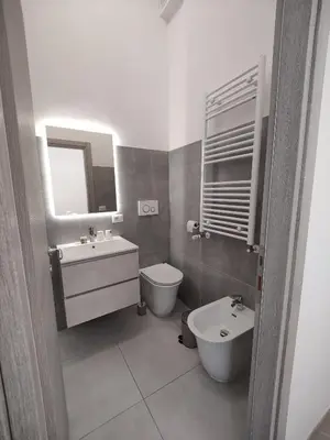 a bathroom with a sink and a toilet and a mirror at Lifestyle 168 Guest House in Rome