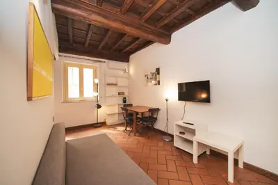 a living room with a couch and a table at Trevi Fountain by BuddyRent in Rome