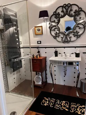 a bathroom with a sink and a shower at Casetta del Bassotto in Rome
