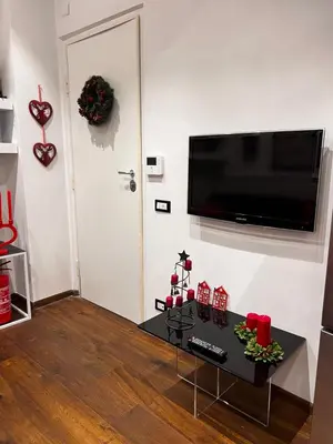 a living room with a flat screen tv on a wall at Casetta del Bassotto in Rome