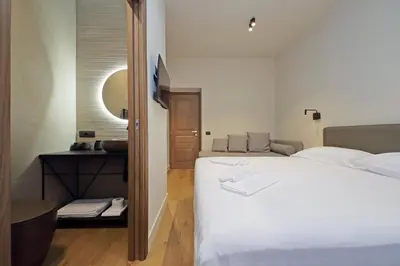 a bedroom with a large white bed and a mirror at The Place Gallia in Rome