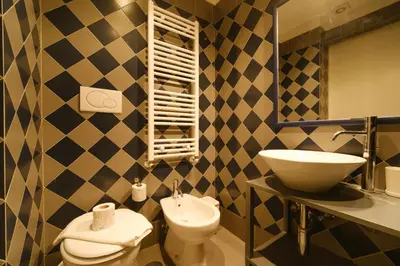 a bathroom with a sink and a toilet at Castel Sant'Angelo by BuddyRent in Rome