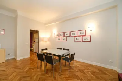 a dining room with a table and chairs at Castel Sant'Angelo by BuddyRent in Rome