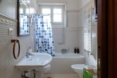 a bathroom with a sink and a toilet and a tub at Olimpico Apartment in Rome