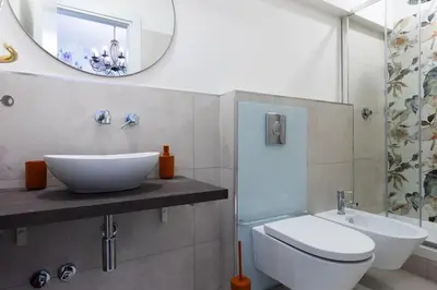 a bathroom with a sink and a toilet and a mirror at Fantastic Rome Guest House in Rome