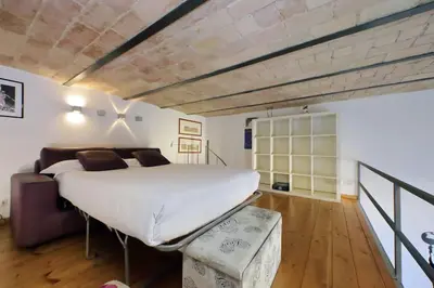 a bedroom with a large bed and a couch at Vatican Luxury Apartment in Rome