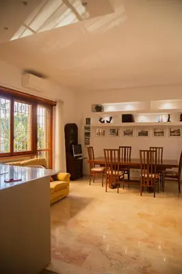 a kitchen and dining room with a table and chairs at Ficus Corner - Vatican in Rome