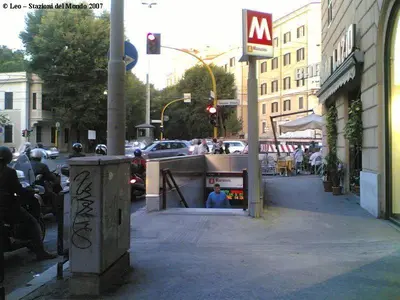a city street with people sitting on the sidewalk at Cherry in Rome in Rome