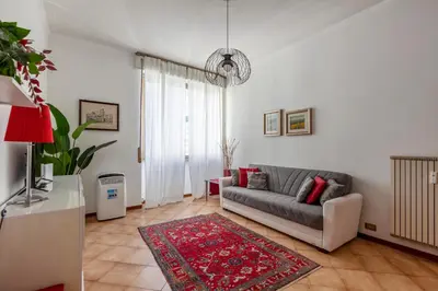 a living room with a couch and a red rug at giovanni house roma in Rome