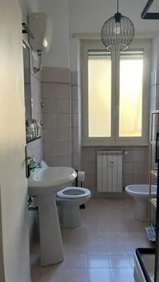 a bathroom with a sink and a toilet and a window at Casa Fiore in Rome