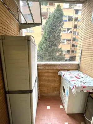 a balcony with a washing machine and a window at Piramide Experience in Rome