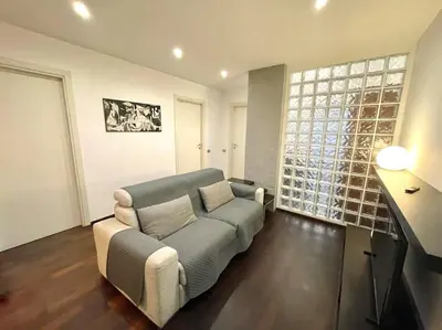 a living room with a couch and a large window at Piramide Experience in Rome