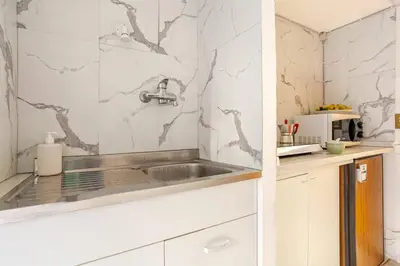 a kitchen with a sink and a counter at Daisy Home - Tiburtina loft in Rome WiFi in Rome